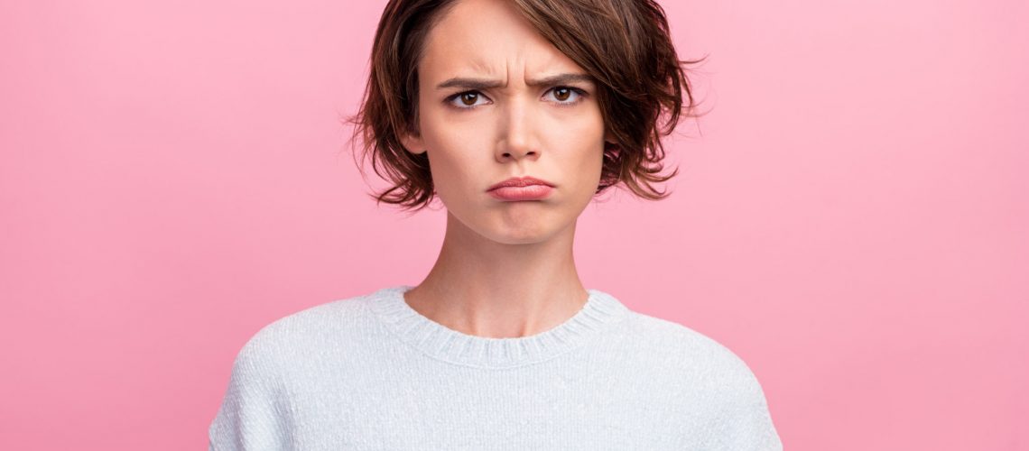 Photo of frustrated grumpy sad lady puffed cheeks lips wear blue sweater isolated pink color background.